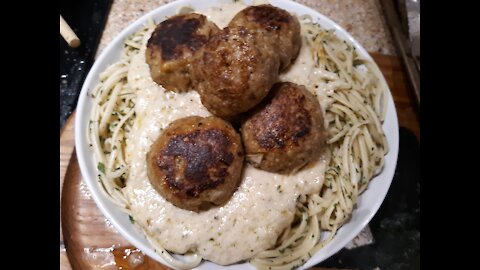 Chicken meatballs w/creamy parmesan sauce on a bed of linguine