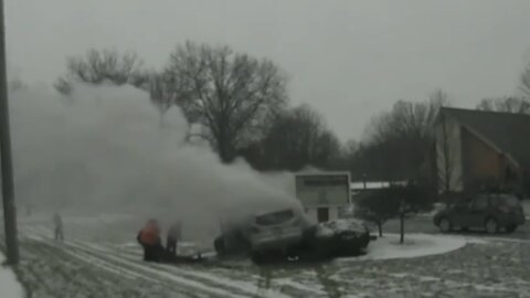 Police Officer and Good Samaritans pull driver from burning car