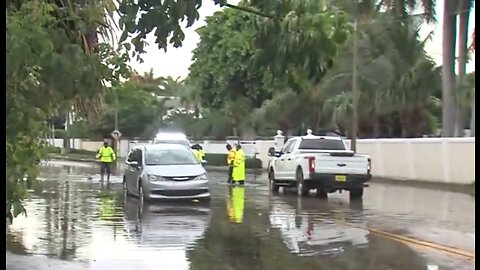 Streets flooded, car stuck in West Palm Beach