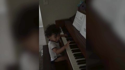 An Adorable Little Boy Plays The Piano