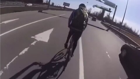 Insane Cyclist Thinks He's A Car, Rides On The Highway, A Semi Truck Sets Him Straight