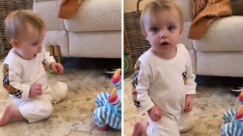 Toddler Unsure How To Deal With New Toy Baby