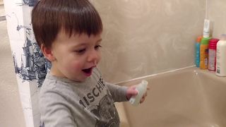 "A Tot Boy Gets Very Excited About Taking A Bath"