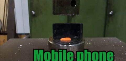 Crushing mobile phone with hydraulic press.