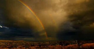 Otrolig dubbel regnbåge under en storm i Australien