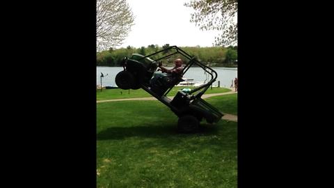 A Man Pulls Over A Tall Antenna With A Tractor And Ends Up Stuck In A Wheelie Position