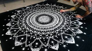 Artist recreates huge mandala symbol using only salt
