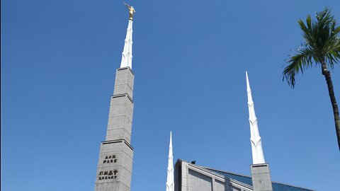 Chatting with some Mormons next to their temple, Taipei ..with their "angel" Moroni (steeple)