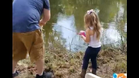 Little girl hooks giant bass during fishing trip
