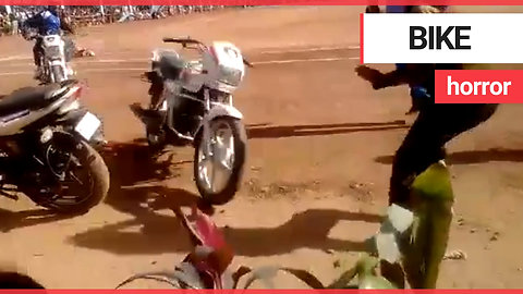 Stuntwoman tries to stand on moving motorbike but loses control