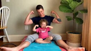 Little girl pulls her own weight during dad's exercise routine