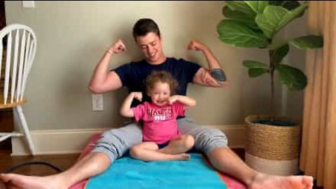 Little girl pulls her own weight during dad's exercise routine