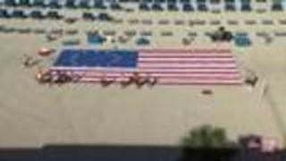 Terry cloth American flag tribute lines beach in front of TradeWinds Island Resort
