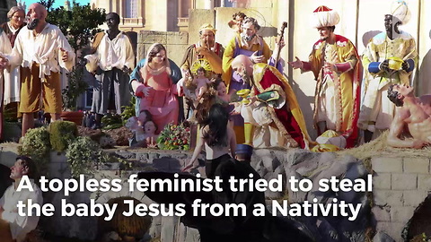 Topless Feminist Tries to Steal Baby Jesus From Manger
