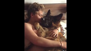 Fluffy puppy cuddles with his owner