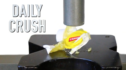 Crushing a lip balm jar with a hydraulic press