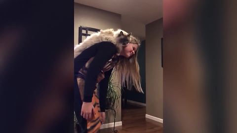 A Teen Girl Rides A Hover Board With A Cat On Her Back
