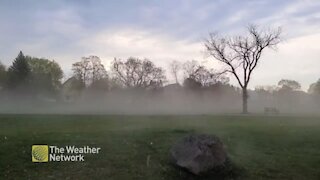 Gusty winds blow sand through parking lot