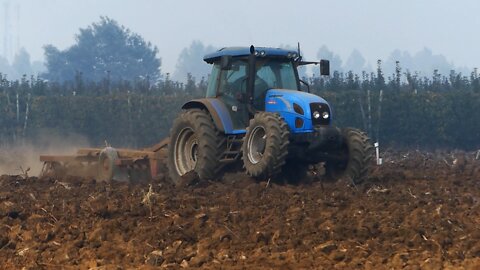 A Tractor Plowing the Field