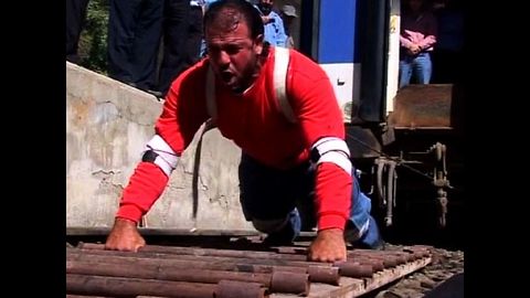 Strongman Pulls Train