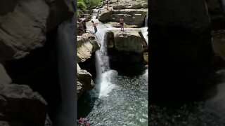 Backflip cliff jumping from amazing Waterfall in Italy