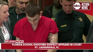Nikolas Cruz, charged with killing 17 people at a Florida high school, walks into Broward County Courthouse with his head down before hearing