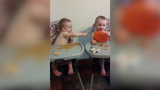 "Adorable Twin Boys Feeding Each Other"