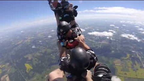 Group of friends jump out of airplane in bobsled formation