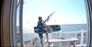 Kitesurfer jumps off balcony in insane move