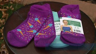 Local girl who fought cancer gives back with socks