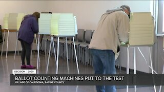 Poll workers test ballot-counting machines ahead of the presidential Election