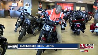 Businesses rebuilding year after major flooding