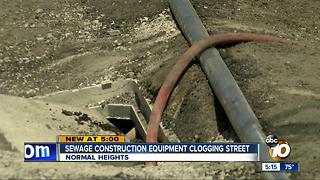 Sewage construction equipment clogging street