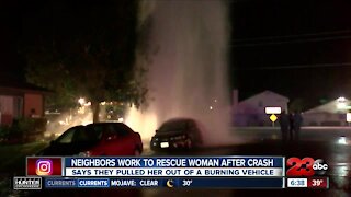 Neighbors work to rescue woman from burning vehicle