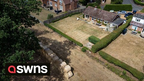 Millionaire estate owner builds wall of hay bales so he doesn't have to look at his neighbours