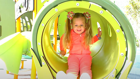 Little girl Diana have fun playing on the Outdoor playground, Kids video
