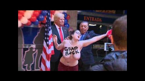 Feminist activist flashes breasts as protest against Trump in Madrid