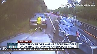 Caught on camera: Tow truck driver just misses getting hit by SUV