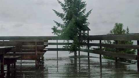 A windy rain storm hitting a wooden terrace