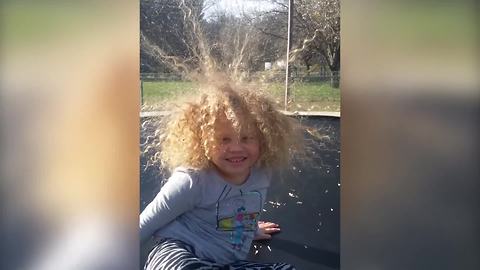 "Girl Plays on A Trampoline and Her Hair Spikes Up"