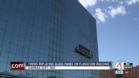 Crews replacing glass panes on Flashcube building