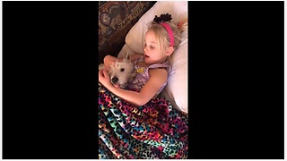 Little Girl Tries To Send Her Pup To Dreamland By Singing A Lullaby