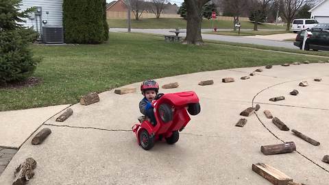 Tot Boy Tips A Toy Car Back And Rides In Circles