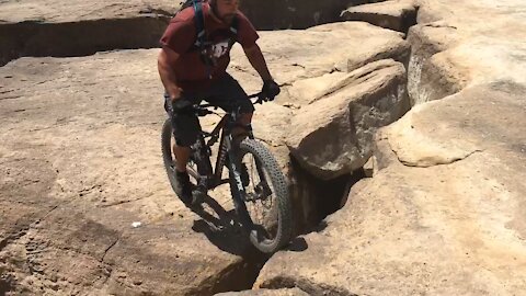 Mountain Biker almost falls off cliff