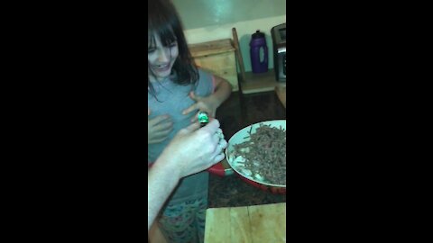 Little girl making mince and onions
