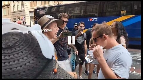 New York: A man eats a kebab in front animal rights activists while they shriek and call him names.