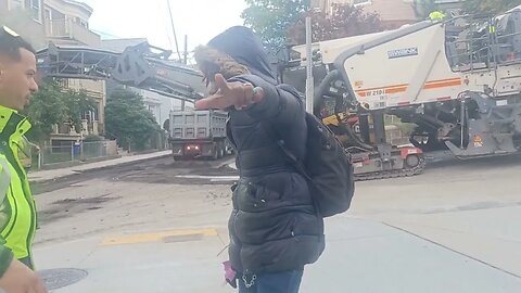 contractors Milling down the asphalt along Center Street in Jamaica Plain