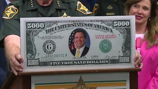 Sheriff Judd presents Governor DeSantis with $5,000 bill