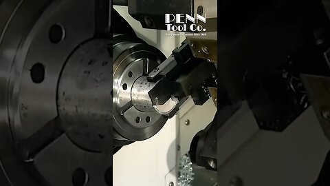 This CNC lathe tool is both a cut-off tool and a bar puller!