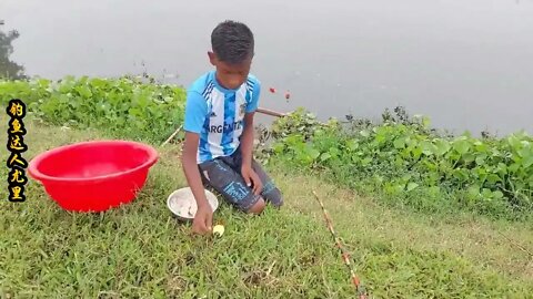 The little boy went fishing by the river and brought home big carp to improve his food +5